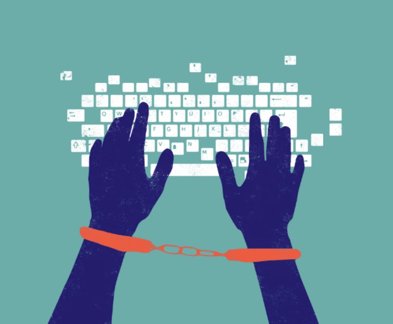 hands in handcuffs on a keyboard